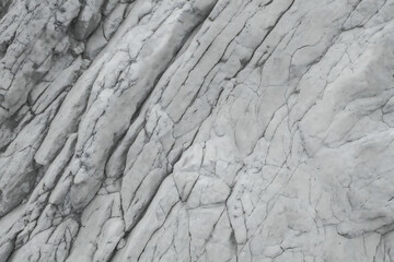 Cracked layered mountain surface with Black white rock texture 