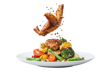 A plated feast a flying chicken wing above grilled meat  vegetables sprinkled with pepper on a white background