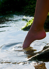 young girl feet in the water