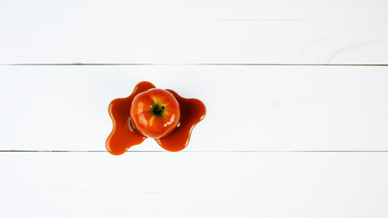 Fresh apple with caramel drizzled on white wooden surface