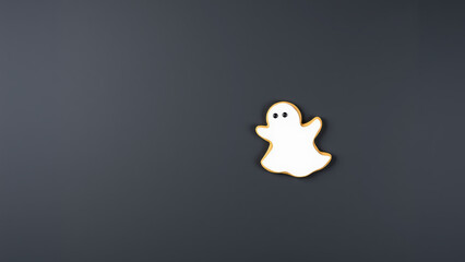 Ghost-shaped cookie on dark background - cute halloween treat design