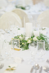 wedding table with exclusive floral arrangement prepared for reception, wedding or event centerpiece in greenery style