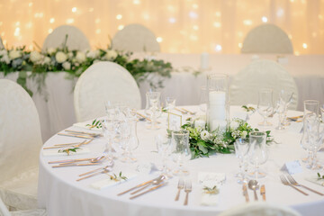 wedding table with exclusive floral arrangement prepared for reception, wedding or event centerpiece in greenery style