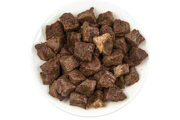 Diced beef cubes on a white plate presented against a white background