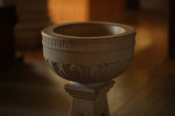 Stone baptismal font standing in church interior