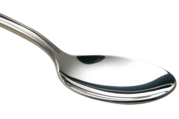 Gleaming silver spoon gracefully curves against a stark black canvas catching light  shadows