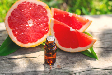grapefruit essential oil in a bottle. Selective focus.