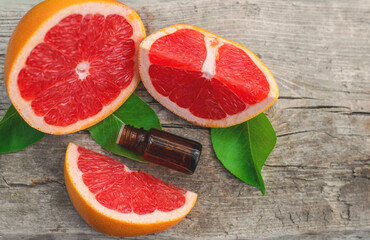 grapefruit essential oil in a bottle. Selective focus.