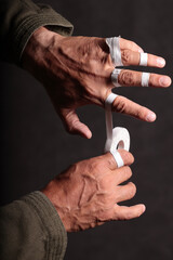 fingers wrapped with protective tape to protect and support against injury before a fight