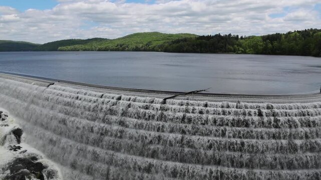water cascading down waterfall at croton dam (man made and natural drinking water reservoir) westchester new york landmark with old bridge (tourism travel hiking destination) nature landscape