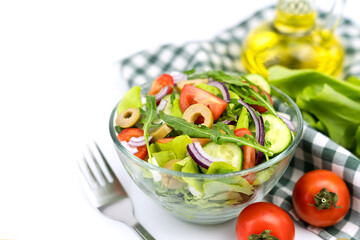 A portion of healthy dietary salad made from fresh vegetables and greens. Close-up. Copy space. Selective focus.