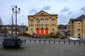 Historic Stone Church with Red Doors in a Cobblestone Square, Batley, West Yorkshire.
