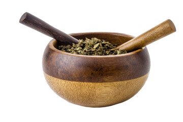 Wooden bowl filled with dried herbs featuring two wooden pestles set against a white background