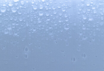 Close up of raindrops on waterproof white fabric