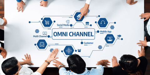 A diverse team collaboratively discussing an omni channel strategy, focusing on enhancing customer experience through social media and mobile apps, emphasizing innovative solutions. Amity