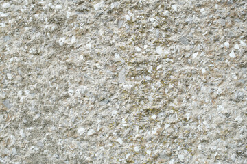 Rough cast concrete wall with stone aggregate A durable and textured surface showing weathering and age