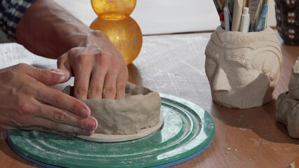 Ceramics artist skillfully shaping clay into a beautiful bowl at his workshop