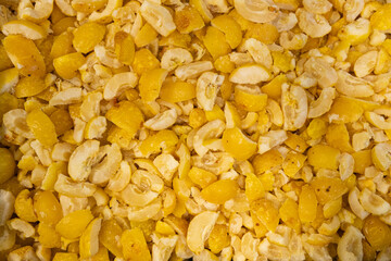 A close-up image showing chopped frozen quinces in various sizes, highlighting their yellow color and icy texture, ideal for culinary use.