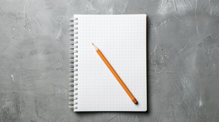 Notepad with grid paper accompanied by a pencil set against a textured backdrop