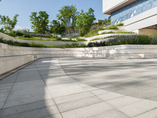 empty concrete square with modern design in green environment of city.