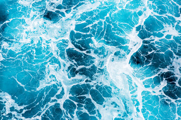 Top view of the Atlantic Ocean's waves and foam as a cruise ship pass by