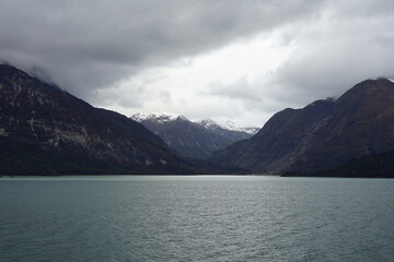 Dramatic Mountain Landscape with Cloudy Sky and Glacier Bay Waters