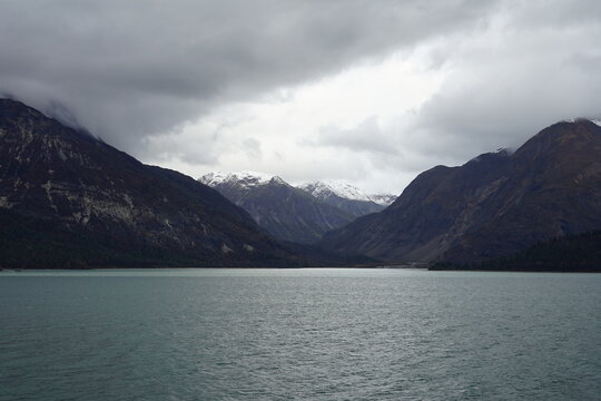 Dramatic Mountain Landscape with Cloudy Sky and Glacier Bay Waters