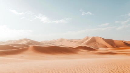 Vast expanse of orange sand dunes under a clear sky.