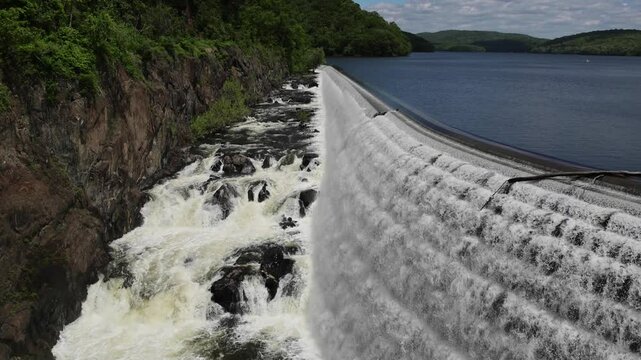 water cascading down waterfall at croton dam (man made and natural drinking water reservoir) westchester new york landmark with old bridge (tourism travel hiking destination) nature landscape