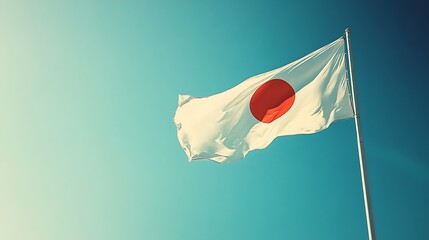 Japanese national flag waving in a clear sky.