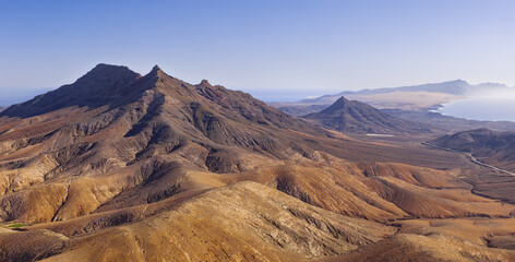 Dramatic aerial panoramic image of Montana Cardon, the Jandia peninsular and the volcanic mountain landscape of Fuerteventura Canary Islands Spain