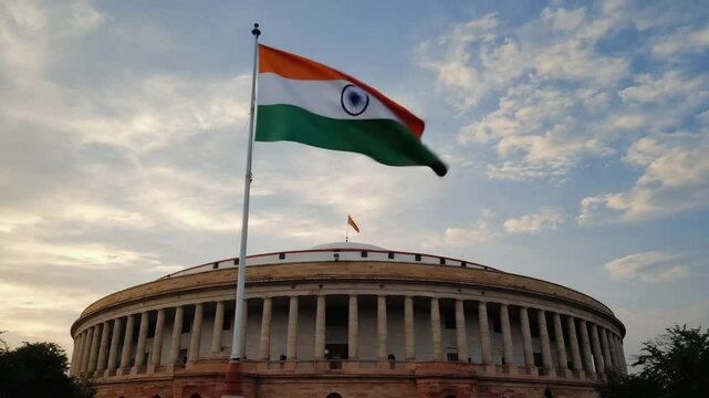 Large Indian Flag Waving High Above the Indian Parliament Building in Delhi