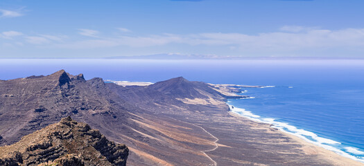 Beautiful high aspect aerial panoramic view of Cofete Beach from Pico de la Zarza the majestic volcanic mountain backdrop in Fuerteventura Canary Islands Spain