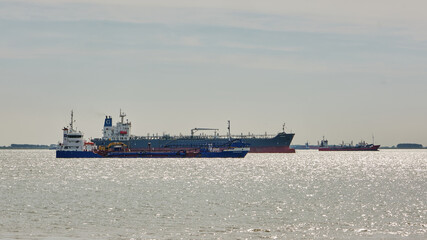 Dredger and cargo ships anchored on the Western Scheldt near Vlissingen