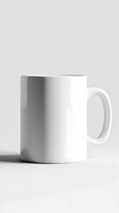 A simple, cylindrical white mug with a C-shaped handle casts a slight shadow on a light gray background
