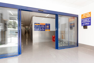 Entrance to a modern self-storage facility with sliding doors