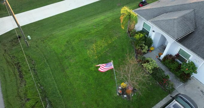 Aerial view of man worker cutting grass in summer with a professional lawn mover vehicle.