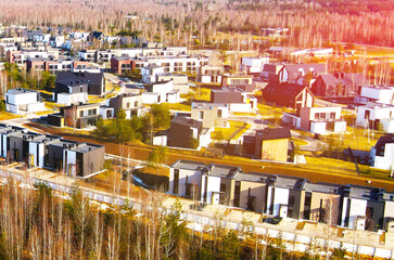 Fototapeta premium Installation of storm sewers and construction of a road in a new residential area. Excavator on earthworks, view from the top, view from the drone. Roadworks soil compactor
