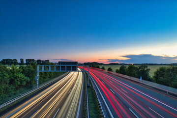 German Autobahn at night - Speed ​​Traffic - Light Trails - Motorway - Long Exposure - Car - Sunset - Vacation