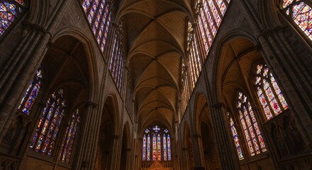 Obraz premium Gothic architecture of St Vitus Cathedral in Prague, showcasing the religious and historic interior with its ancient arches, stained glass windows, and soaring nave