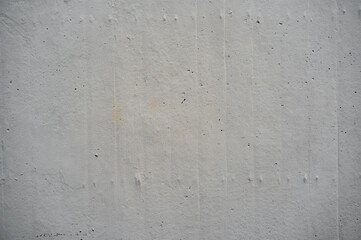 Textura de muro de concreto gris con detalles de desgaste y líneas verticales