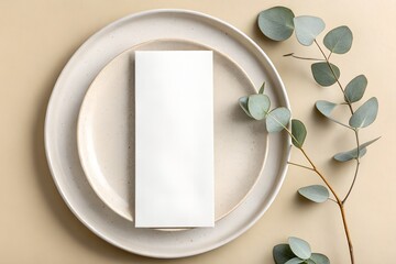 Elegant place setting with blank menu card and eucalyptus