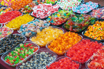 colorful marmalade and chewable candies on counter at candy store in the oriental market