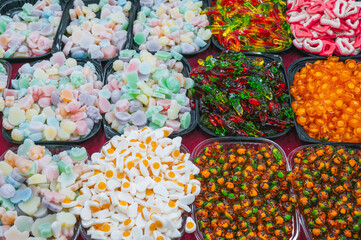 assortment of sweets marmalade and chewable candies on the counter at a candy store in oriental market