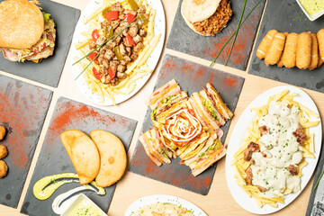 Delicious venezuelan food arranged on a table, featuring arepas, tequenos, patacones, and other popular dishes
