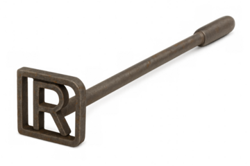 Rusty branding iron with letter r laying on transparent background, showing concept of livestock marking