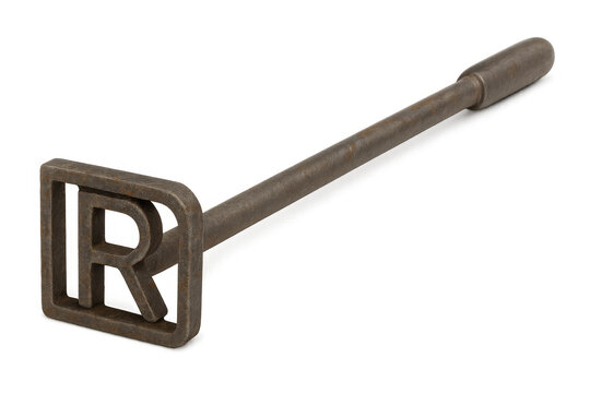 Rusty branding iron with letter r laying on transparent background, showing concept of livestock marking