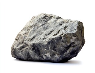A substantial, dark gray rock, roughly hewn, rests on a plain white background.  Its surface is uneven with various textures and crevices, a natural form