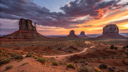 Monument valley at sunset with dramatic clouds and a winding dirt road through the desert landscape created with generated ai