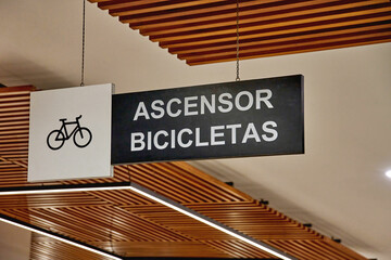Shopping center bicycle elevator sign in modern mall design, showcasing accessibility for cyclists and promoting eco-friendly transport concept